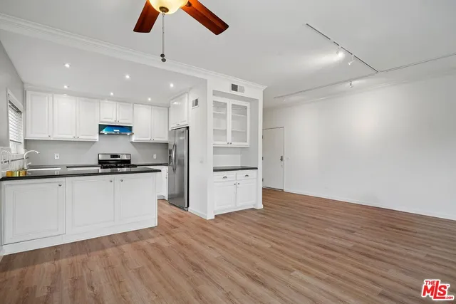 a kitchen with granite countertop a stove and a refrigerator