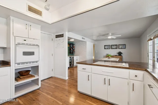 a kitchen with granite countertop white cabinets and white appliances