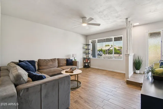 a living room with furniture and a wooden floor