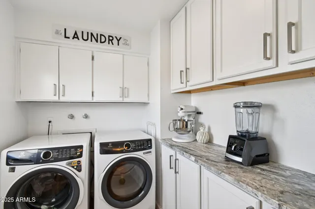 a view of a kitchen with sink washer and dryer