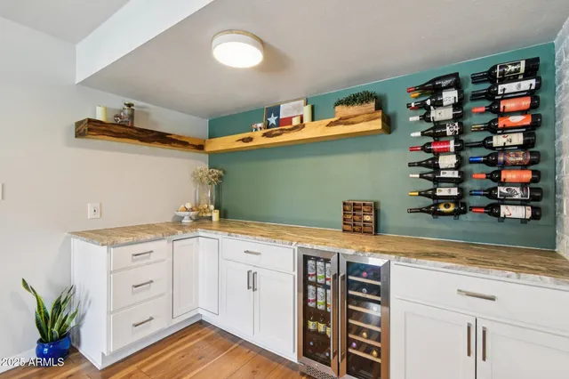 a view of a kitchen with cabinets and wooden floor