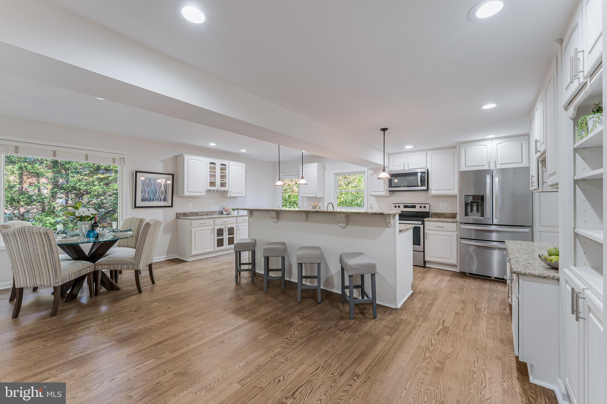 13430 Hidden Meadow Court Herndon, VA 20171 - Photo 14 of 54 a open kitchen with white cabinets and stainless steel appliances