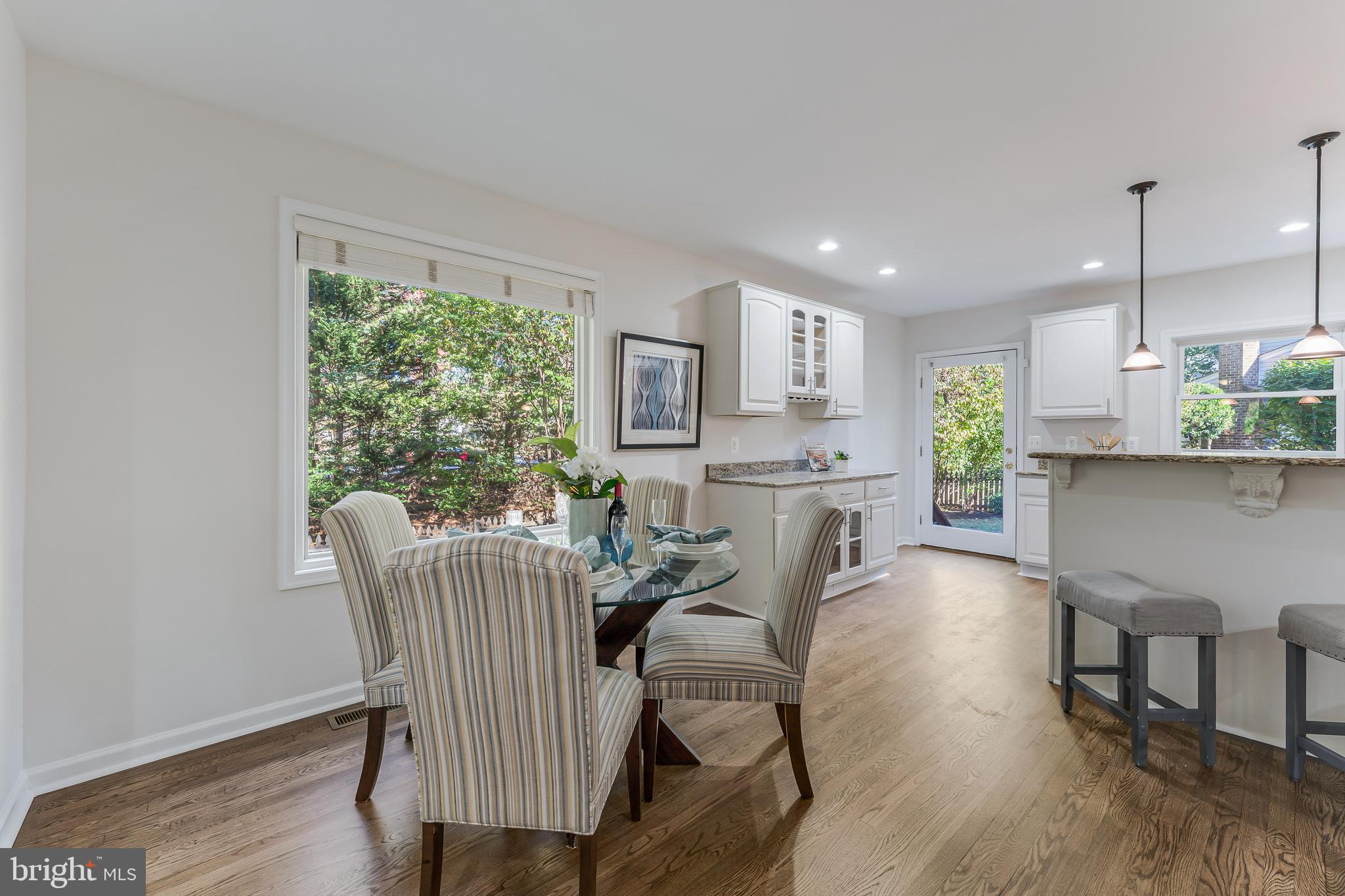 13430 Hidden Meadow Court Herndon, VA 20171 - Photo 21 of 54 a view of a dining room with furniture and a wooden floor