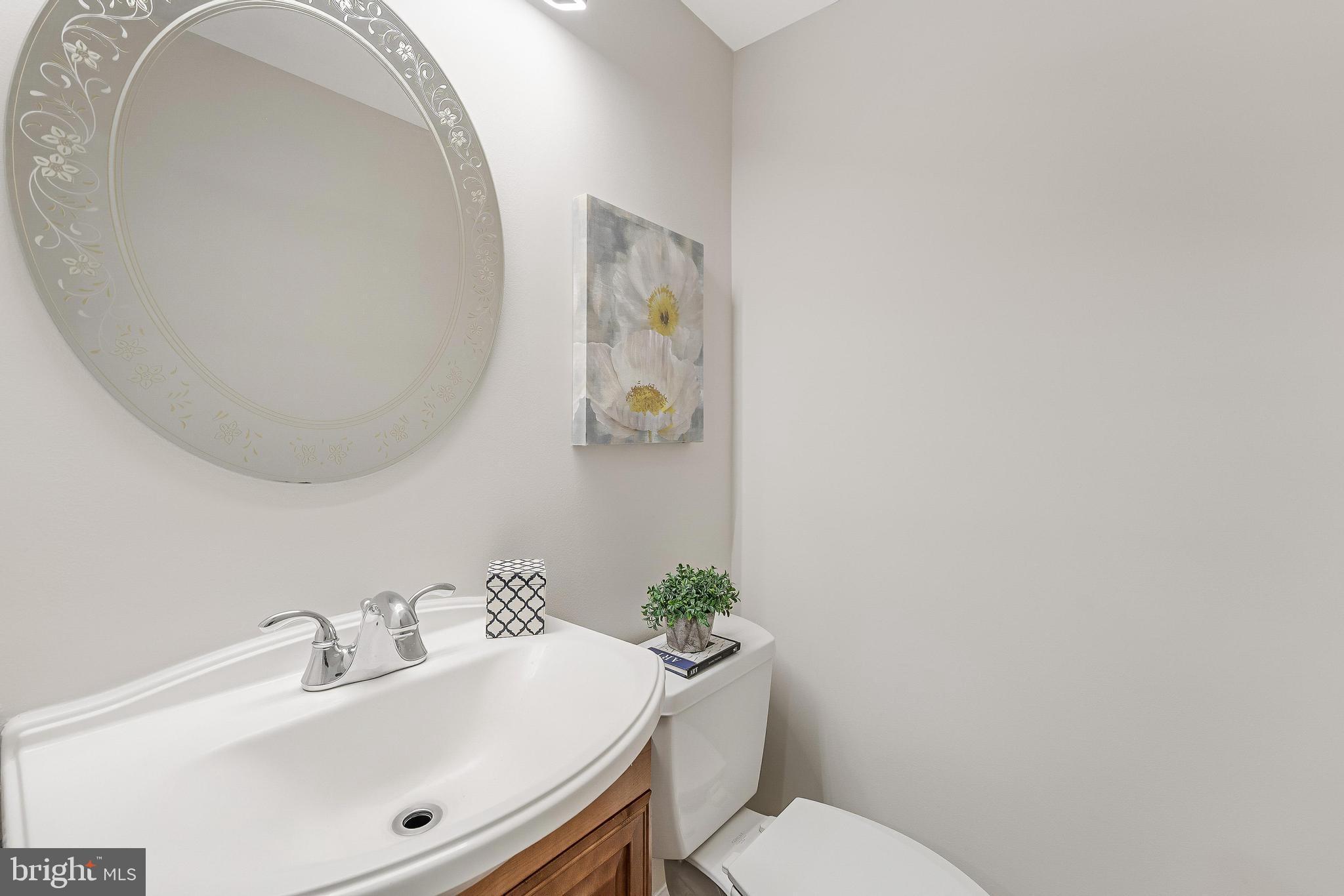 13430 Hidden Meadow Court Herndon, VA 20171 - Photo 26 of 54 a bathroom with a sink mirror and toilet