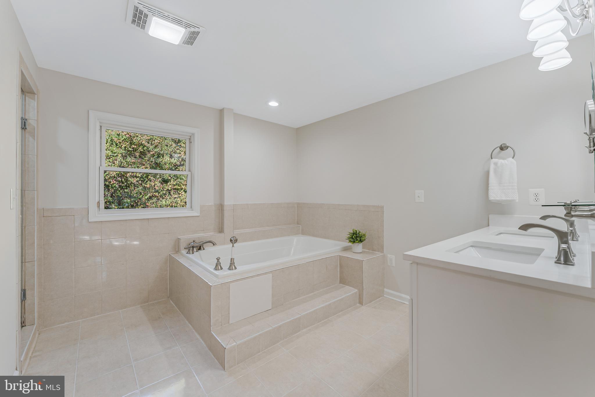 13430 Hidden Meadow Court Herndon, VA 20171 - Photo 33 of 54 a bathroom with a sink a bathtub and a window