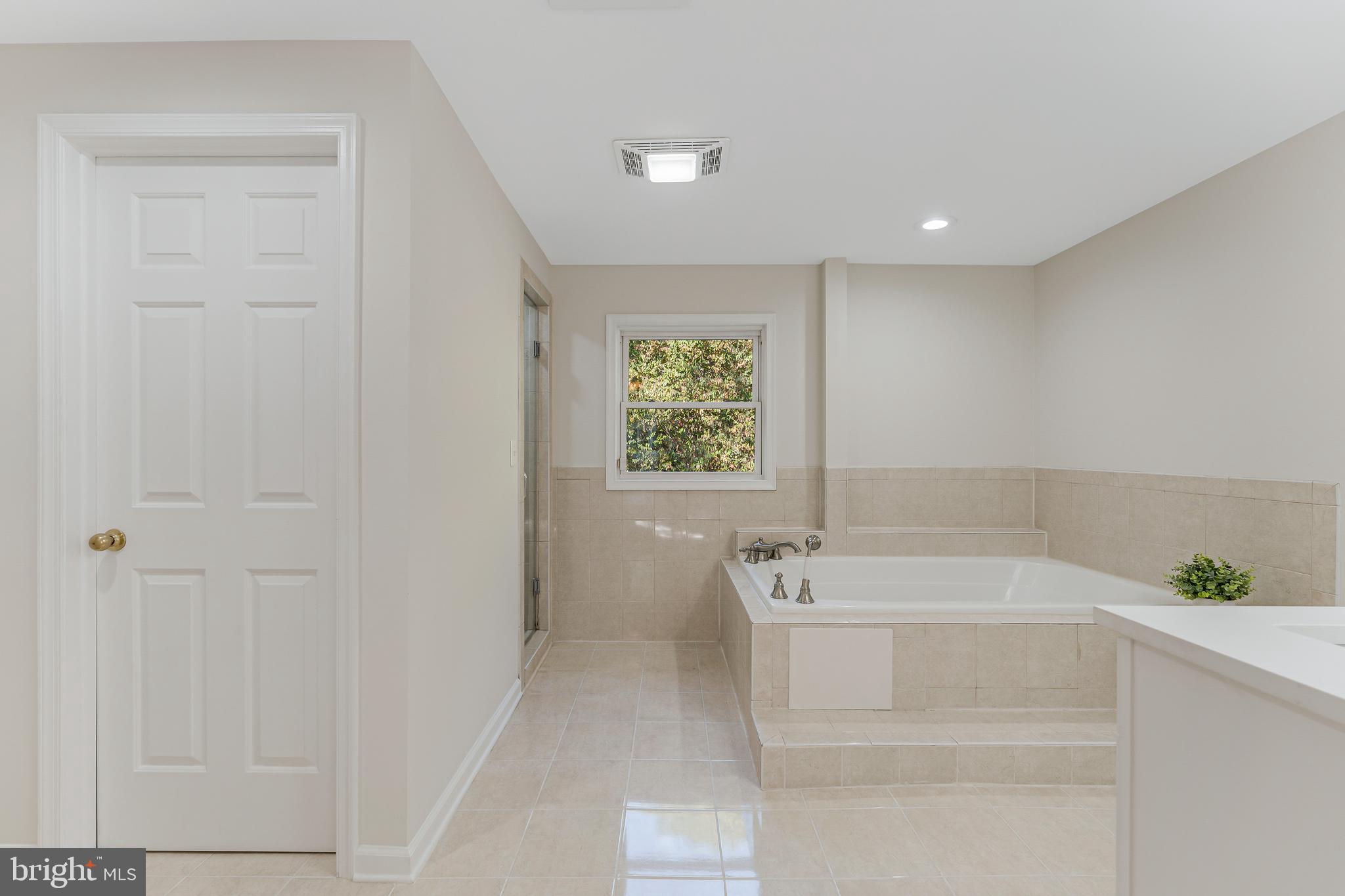 13430 Hidden Meadow Court Herndon, VA 20171 - Photo 34 of 54 a bathroom with a sink a bathtub and a window