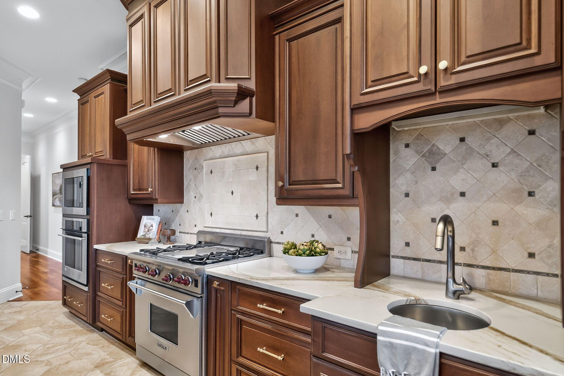 4119 English Garden Way Raleigh, NC 27612 - Photo 22 of 48 a kitchen with stainless steel appliances granite countertop a sink stove oven and white cabinets