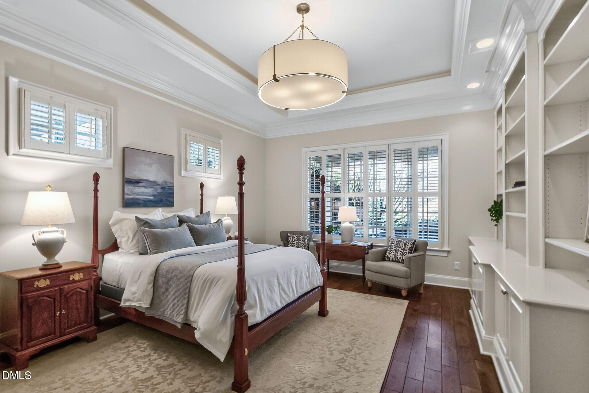 4119 English Garden Way Raleigh, NC 27612 - Photo 26 of 48 a bedroom with a large bed and a chandelier