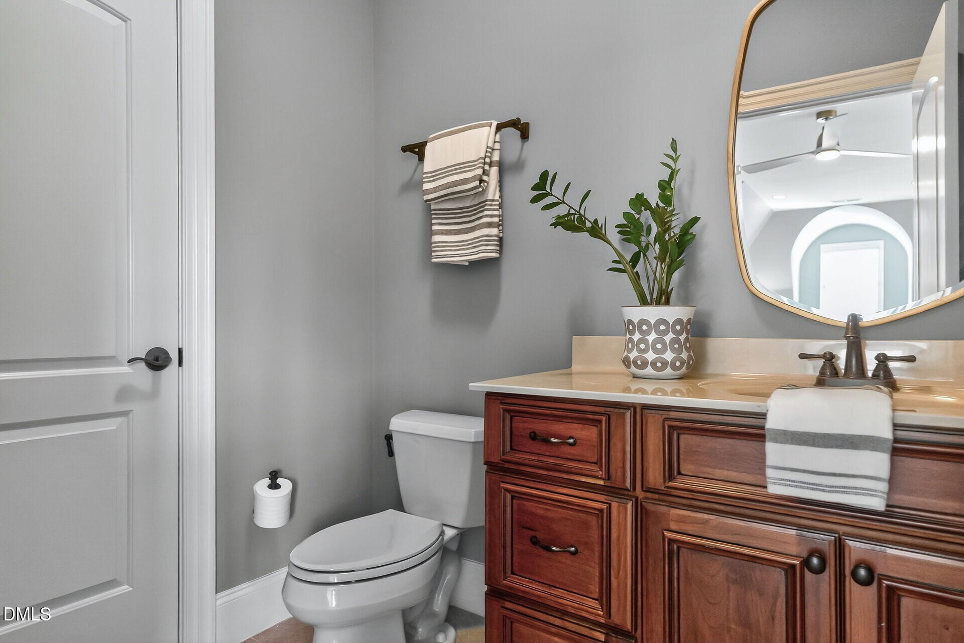 4119 English Garden Way Raleigh, NC 27612 - Photo 40 of 48 a bathroom with a toilet a sink and mirror