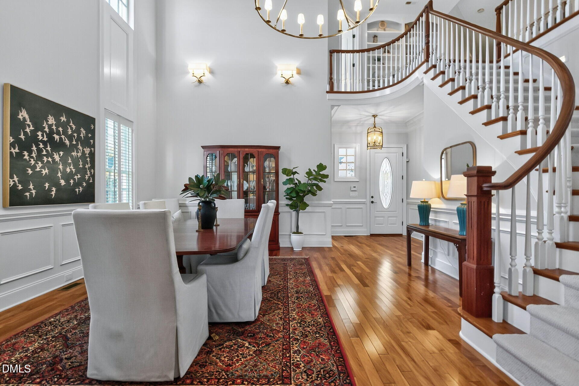 4119 English Garden Way Raleigh, NC 27612 - Photo 9 of 48 a dining room with wooden floor a chandelier a wooden table and chairs