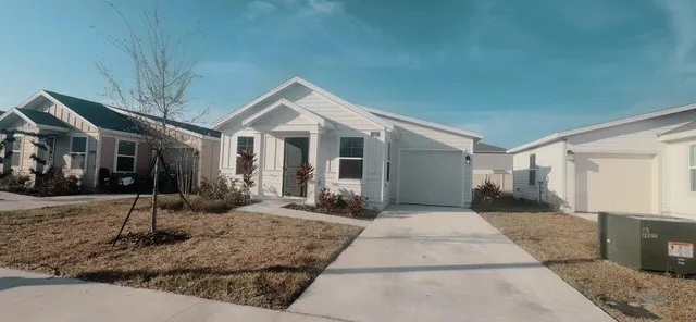 a front view of a house with garden and patio