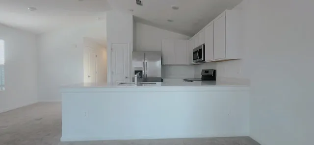 a view of kitchen with cabinets