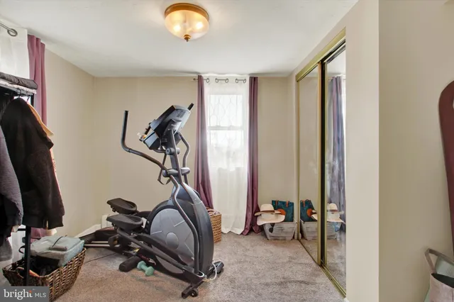 a bedroom with a bed and a chair in it