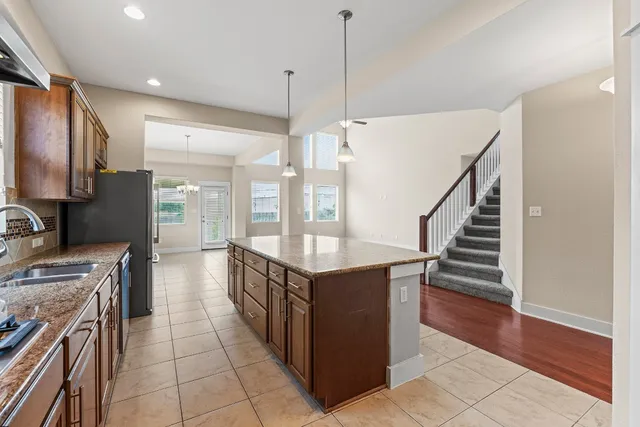 a kitchen with stainless steel appliances granite countertop a stove and a sink