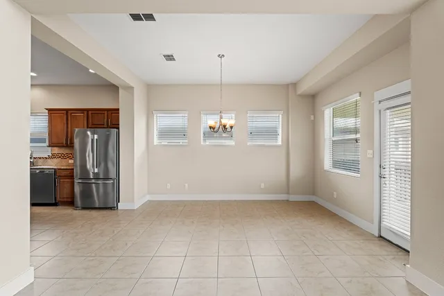 a view of a kitchen with a sink and a refrigerator