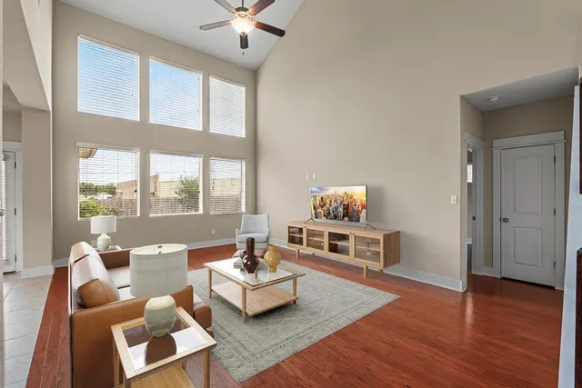a living room with furniture and a wooden floor