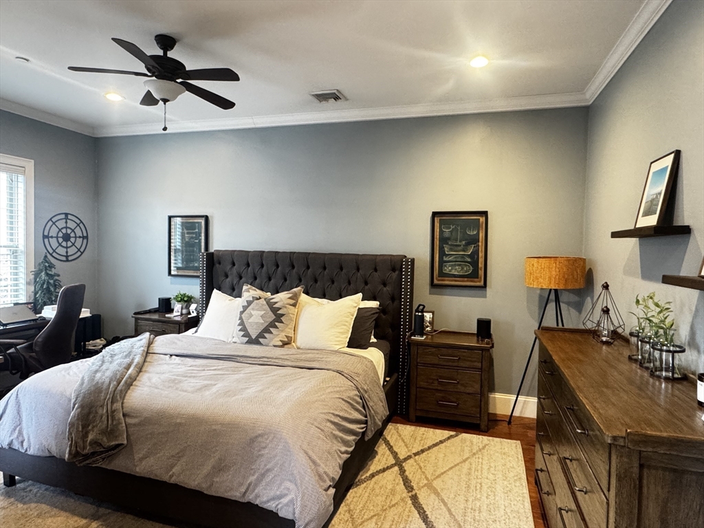 42 R Olney Street, Unit 2 Boston, MA 02121 - Photo 9 of 17 a bedroom with a bed and a chandelier