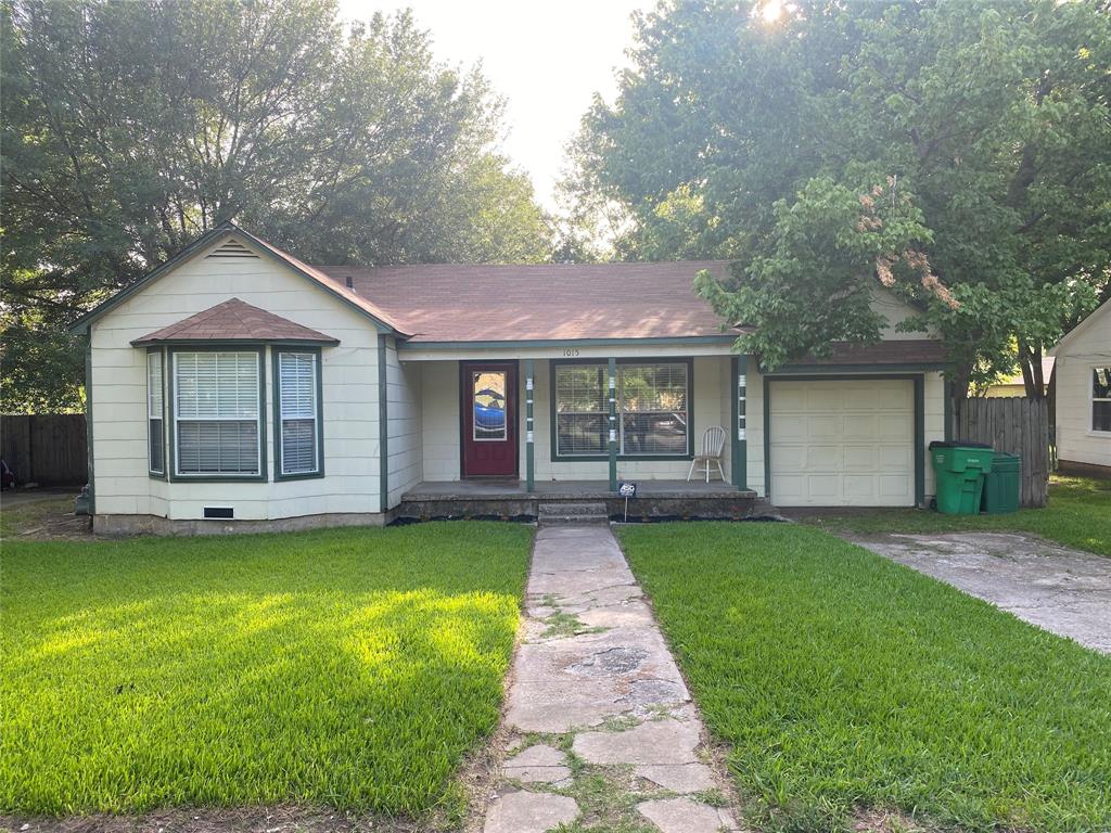 1015 North Howeth Street Gainesville, TX 76240 - Photo 1 of 1 a front view of a house with a garden and yard