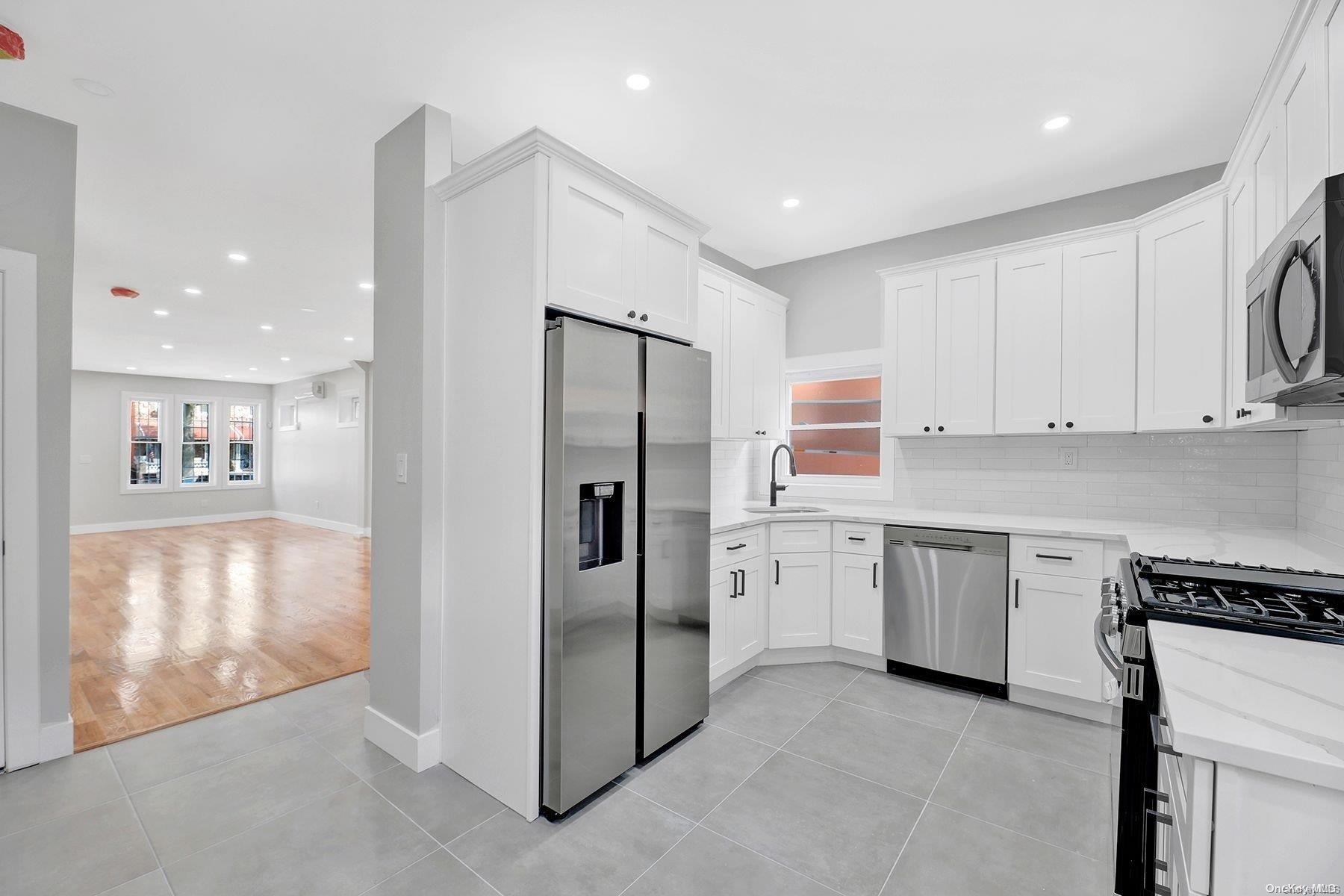 a kitchen with stainless steel appliances granite countertop a refrigerator and a stove top oven