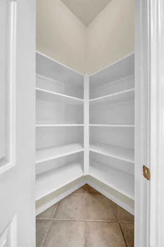 a kitchen with granite countertop a refrigerator and a stove top oven