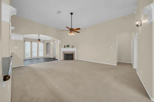 a view of a livingroom with a fireplace and a chandelier