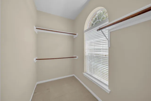 a bathroom with a toilet a sink a mirror a bathtub and vanity