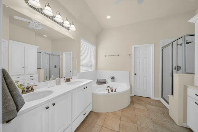 a bathroom with a tub sink and mirror