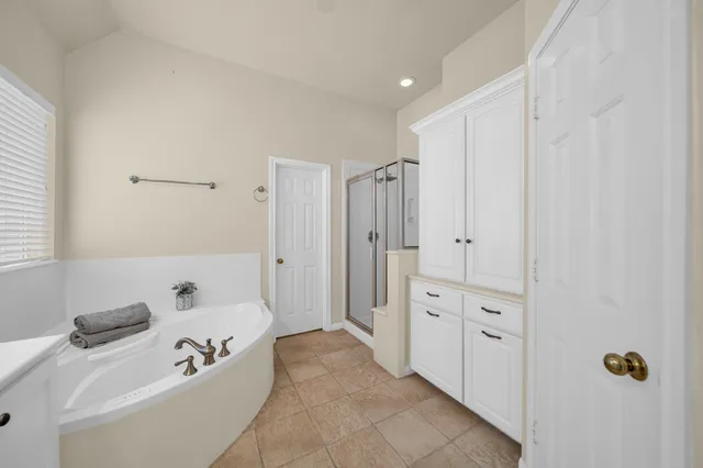 a bathroom with a double vanity sink mirror and shower