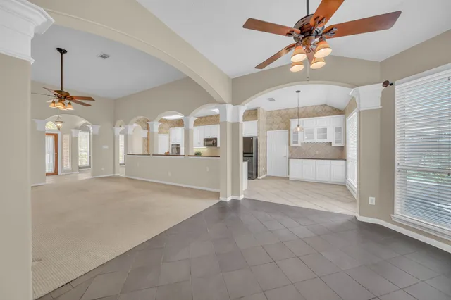 a front view of a house with a garden and plants