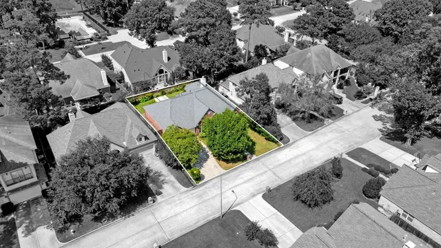 an aerial view of a house with a yard and garden