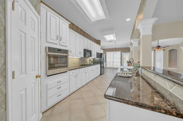 a large kitchen with stainless steel appliances granite countertop a lot of counter space and cabinets