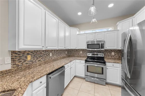 a kitchen with stainless steel appliances granite countertop a sink stove oven and refrigerator