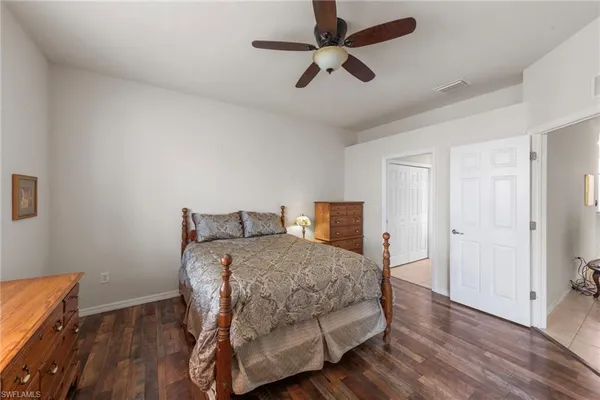a bedroom with a bed chandelier and a window