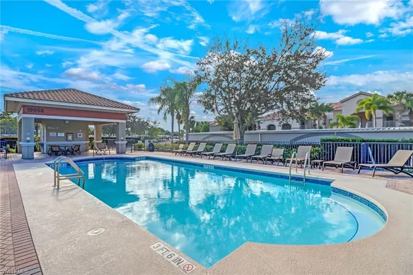 a view of a swimming pool with outdoor seating