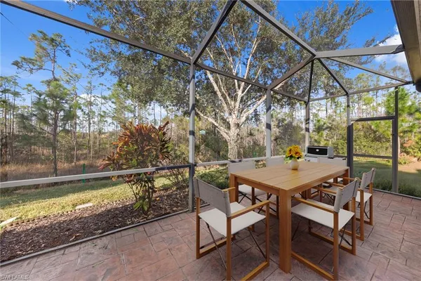 a view of backyard with a table and chairs under an umbrella