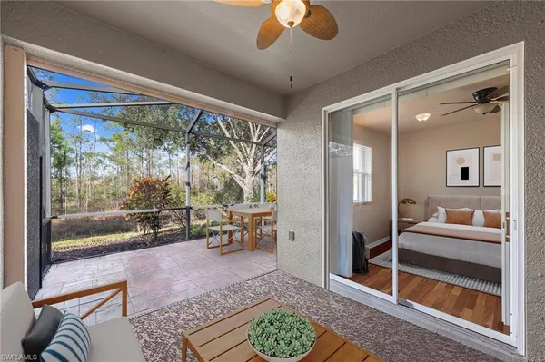 a living room with furniture and a floor to ceiling window