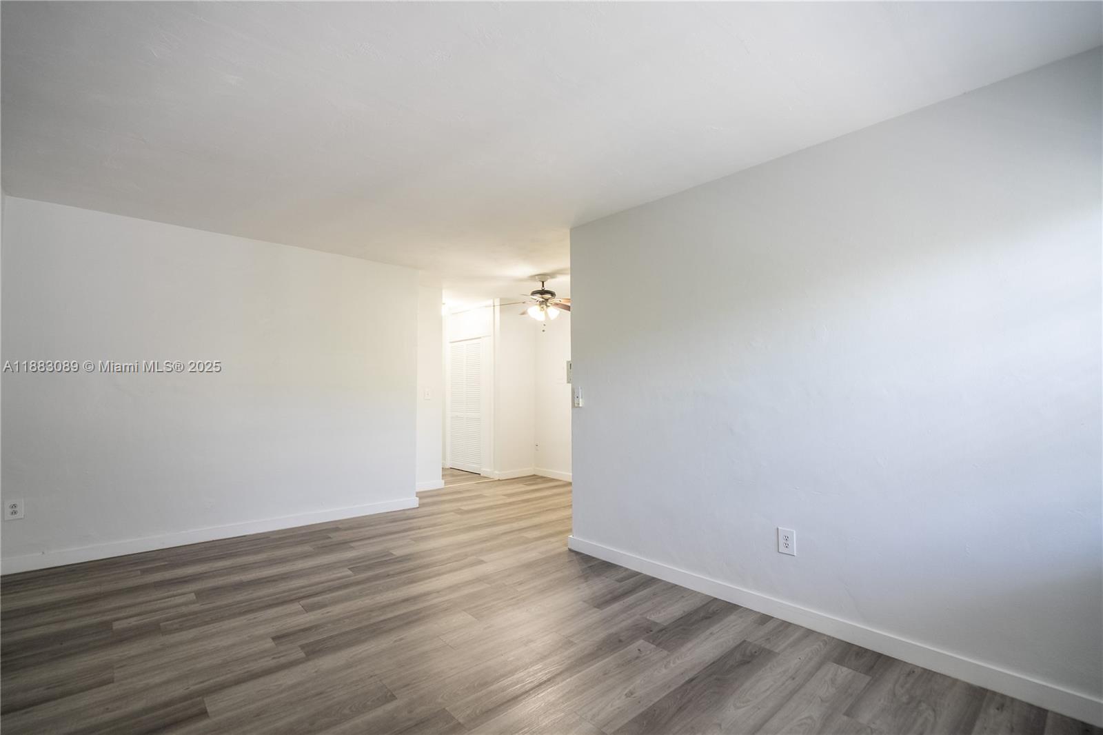 1190 71st Street, Unit 9 Miami Beach, FL 33141 - Photo 3 of 15 a view of an empty room with wooden floor