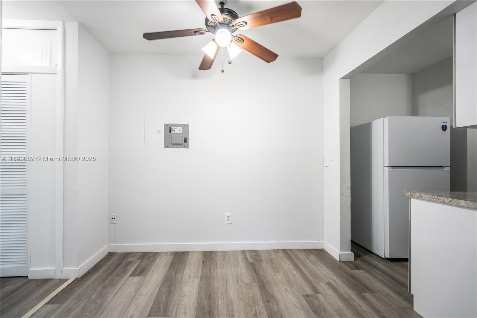 1190 71st Street, Unit 9 Miami Beach, FL 33141 - Photo 6 of 15 a view of empty room with wooden floor and fan