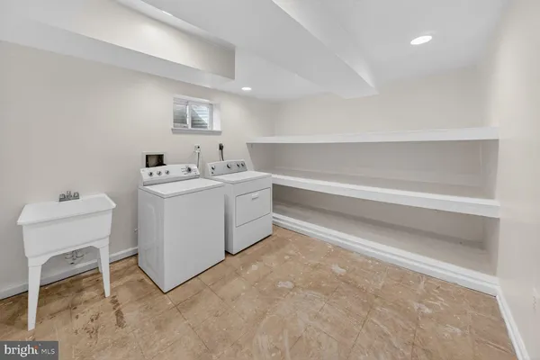 a utility room with cabinets dryer and washer