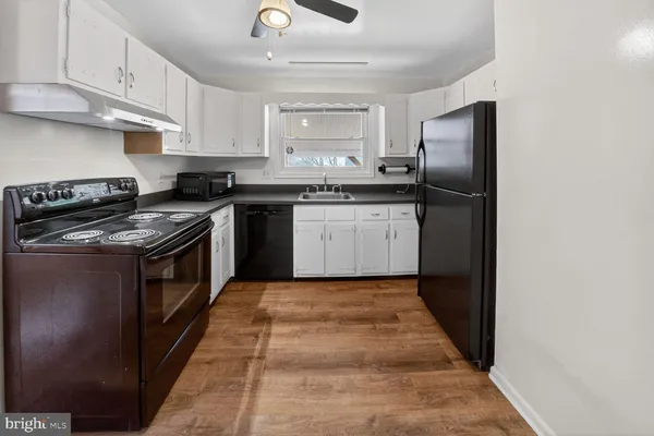 a kitchen with stainless steel appliances granite countertop a stove a refrigerator and a sink