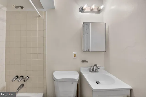 a bathroom with a sink a toilet and mirror