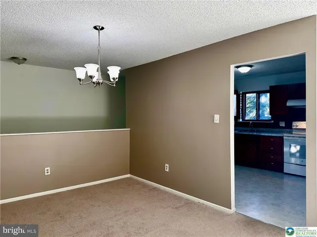 a kitchen with granite countertop wooden cabinets a sink and dishwasher