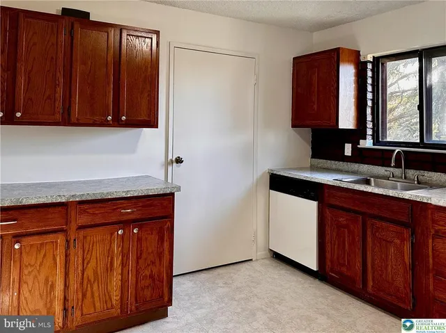a view of a storage & utility room with a sink