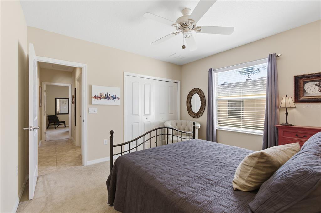 48 Evans Drive Palm Coast, FL 32164 - Photo 29 of 47 a bedroom with a bed and a chandelier