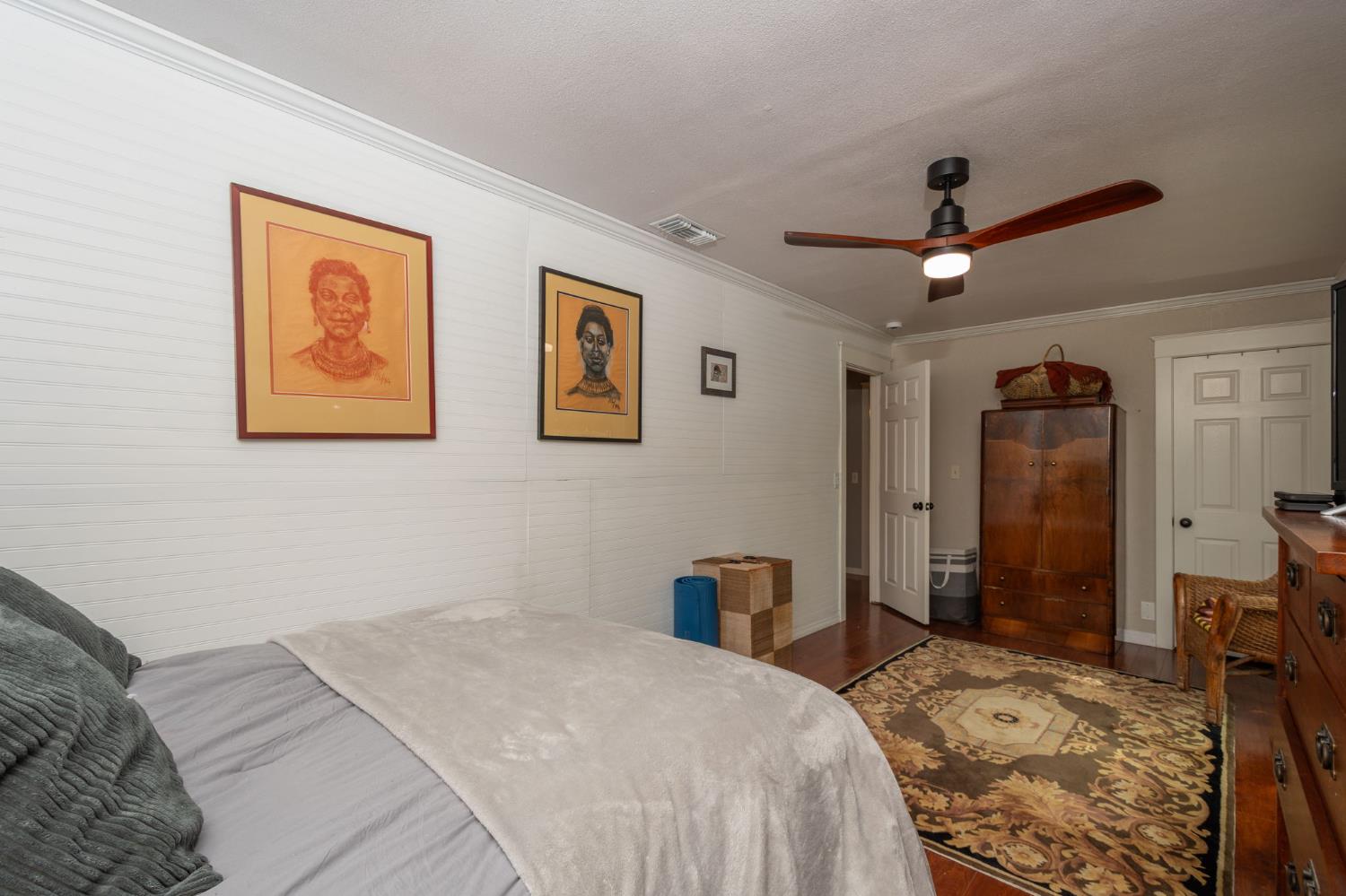 15663 Ojai Road Santa Paula, CA 93060 - Photo 14 of 47 a bedroom with a large bed and a chandelier