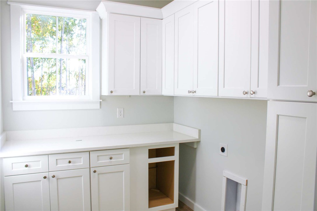 2515 Highway 29 Anderson, SC 29621 - Photo 32 of 38 White cabinetry with ample counter space creates a functional and neat laundry area.