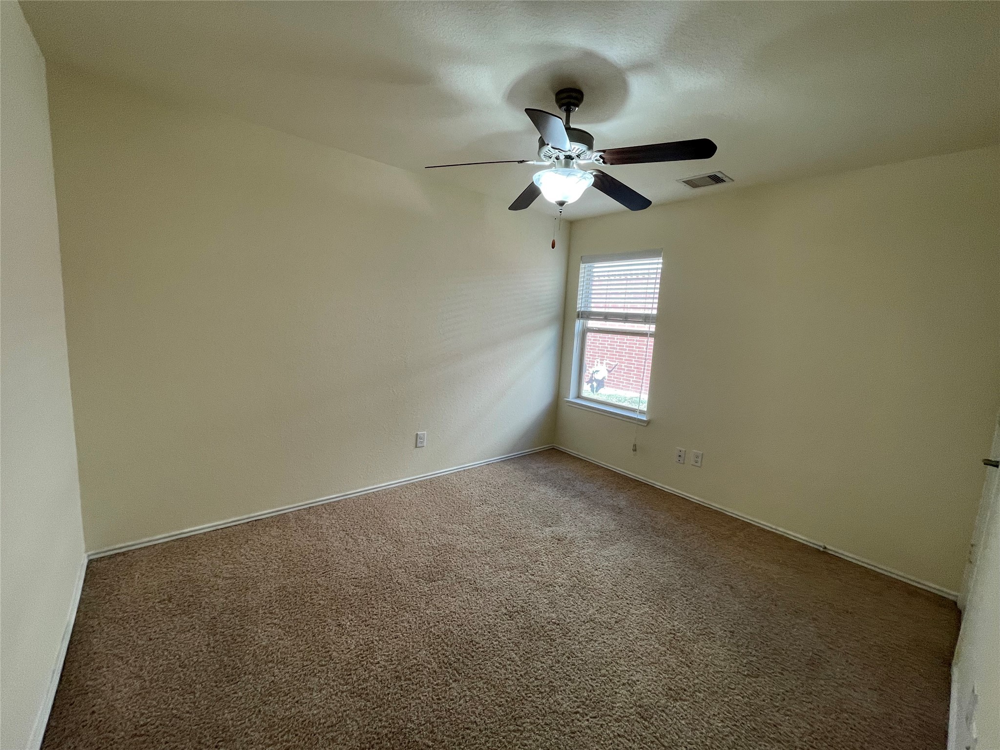12010 Ramla Place Trail Houston, TX 77089 - Photo 13 of 24 an empty room with a window and a fan