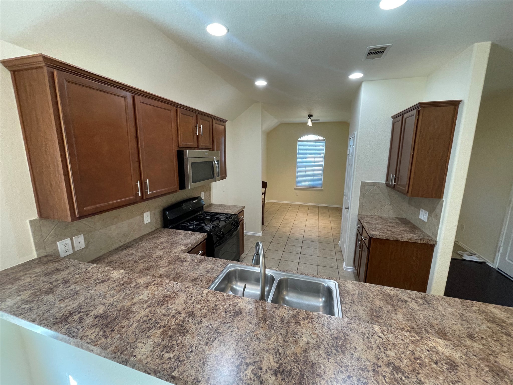 12010 Ramla Place Trail Houston, TX 77089 - Photo 6 of 24 a kitchen with sink a refrigerator and granite counter tops