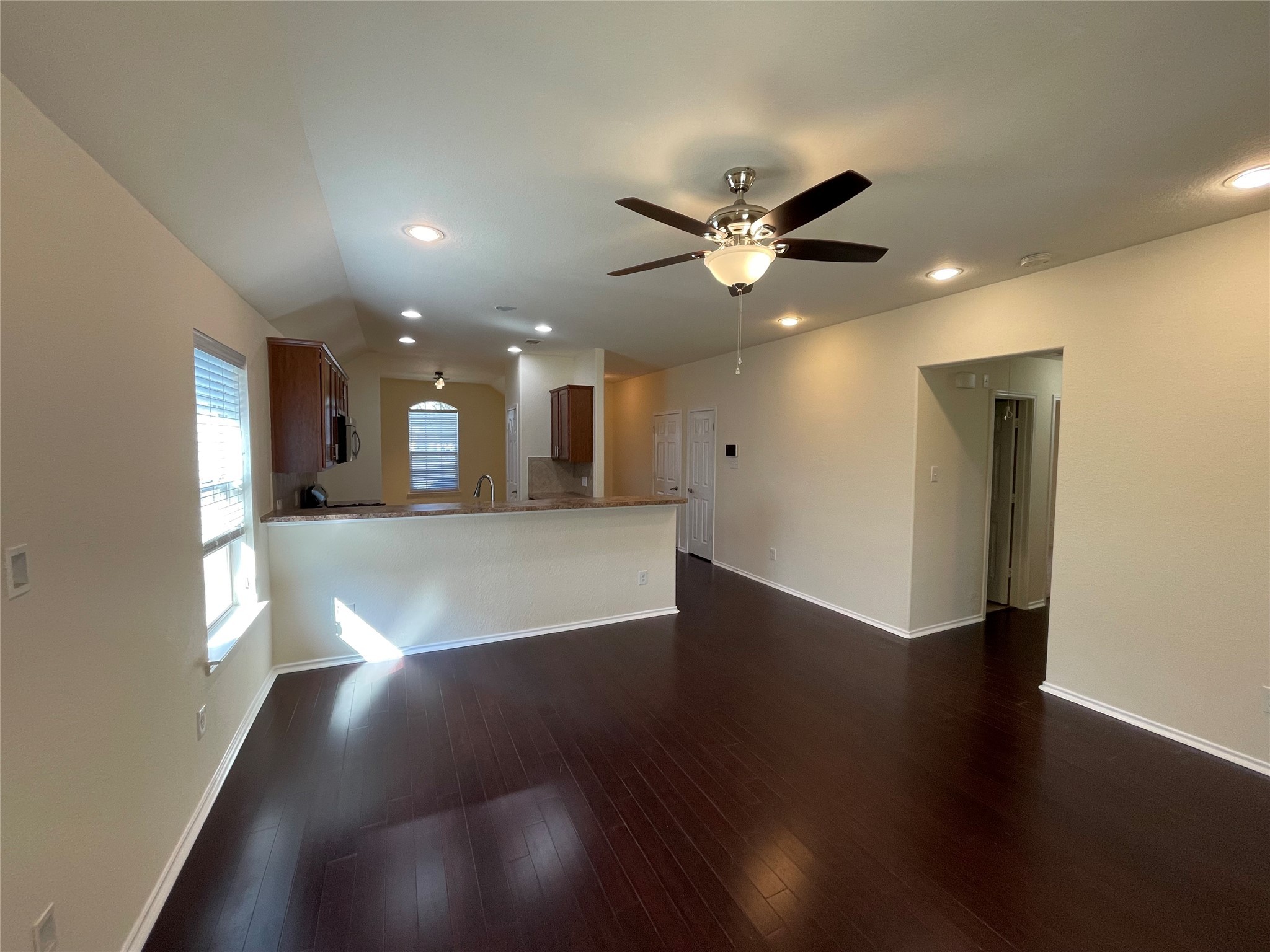 12010 Ramla Place Trail Houston, TX 77089 - Photo 9 of 24 a view of a big room with wooden floor and a kitchen