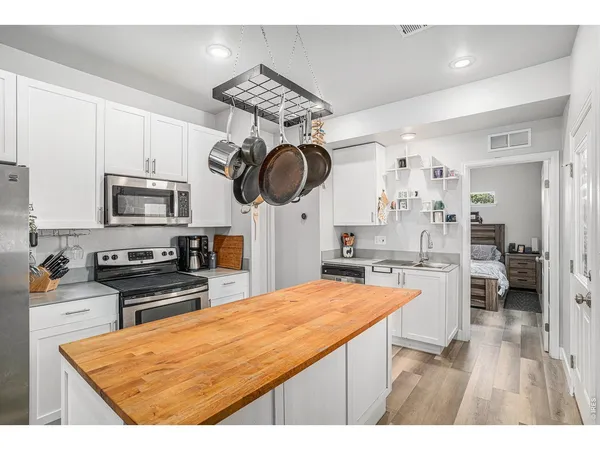 a kitchen with stainless steel appliances granite countertop a stove a sink and a refrigerator